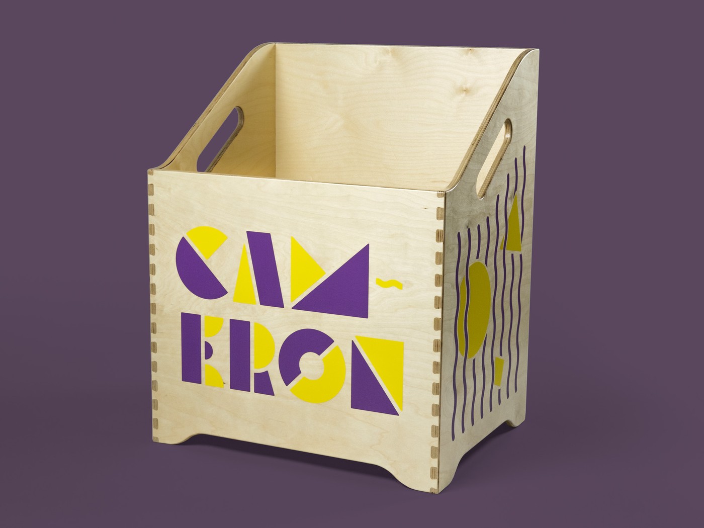 Plywood box on a purple background. Purple and yellow geometric shapes and wavy lines applied to the sides.