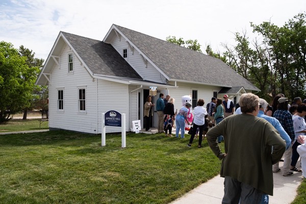 People stand in line at the entrance to the Hall