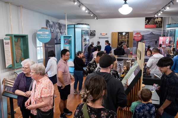 Dozens of people fill the exhibit space