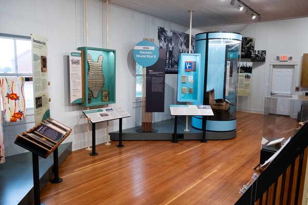 A range of displays from baseball catcher's pads to World War II V-Mail in blue and blue-green cases