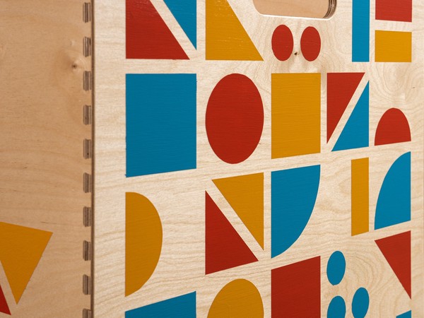 close up of a wooden surface covered in colorful geometric shapes