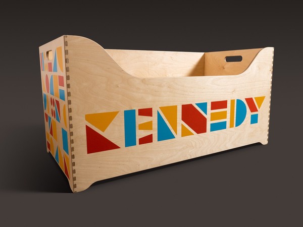 light wood box with the name Kennedy made of abstract simple shapes on the front