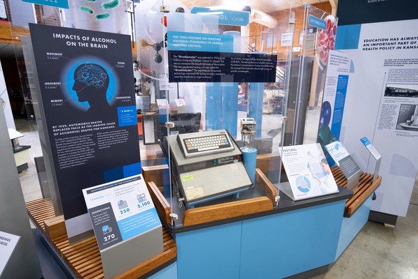 An boxy electronic device with a keyboard and content about alcohol and impaired driving displayed on the blue exhibit