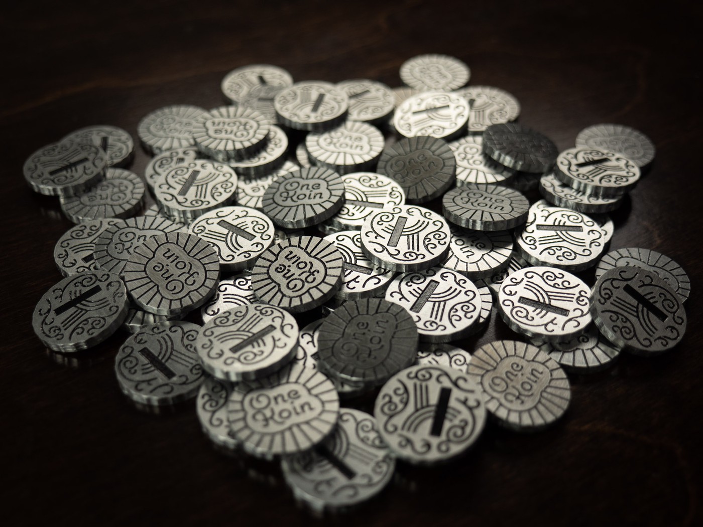 dramatically lit pile of coins against dark background