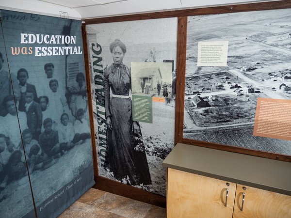 Homesteading interpretive panel shows large reproduction of historic photo of woman