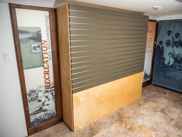 olive green slatwall next to Recreation interpretive panel