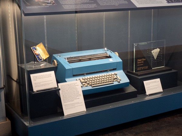 Eagle Scout Pin, typewriter, and glass award inside display case